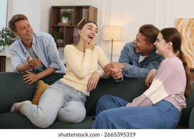 friends-laughing-on-sofa-indoors-260nw-2665395319